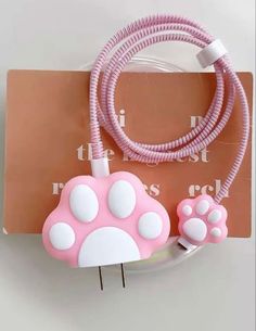 a pink and white cat paw plugged into a charger