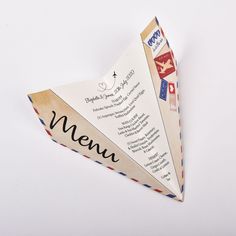 an origami paper airplane with the word menu written on it