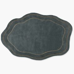 a gray rug with gold trimmings on the edges and an oval shaped area