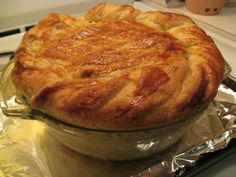 a pie sitting on top of a pan covered in tin foil