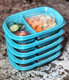 a stack of blue plastic containers filled with food