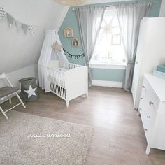 a baby's room is decorated in blue and white with stars on the ceiling