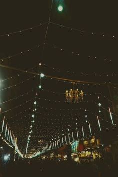 the lights are hanging from the ceiling above the street at night, and there is no image here to provide a caption for