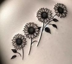 some very pretty sunflowers on the side of a woman's stomach,