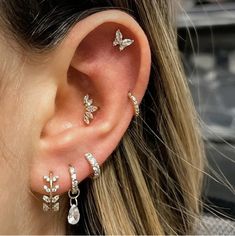 a close up of a person's ear with three different types of piercings