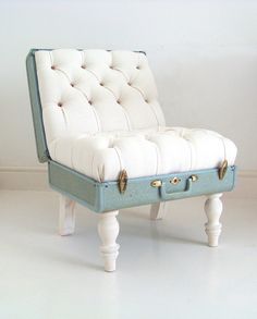 an upholstered bench with buttons on the back and legs is shown in front of a white wall