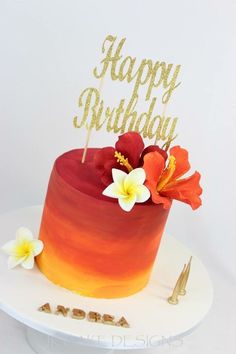 a red and orange ombrella cake with gold happy birthday topper on it