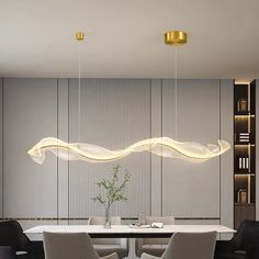 an elegant dining room with modern lighting fixtures