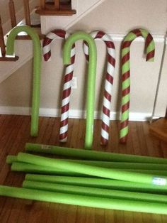 green and white candy canes lined up on the floor in front of some stairs