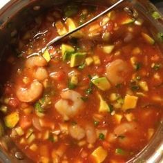 a pot filled with shrimp and vegetable soup