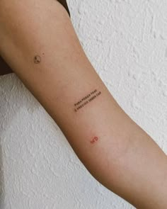 a person with a tattoo on their arm that reads, i am not sure what this is