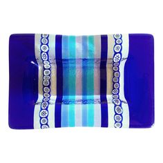 a blue and white striped glass dish on a white background with an ornate border around the edge