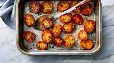 a pan filled with cooked potatoes on top of a table