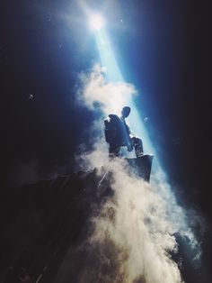 a man is standing on top of a building in the clouds