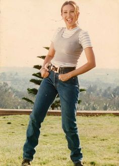 a woman standing on top of a lush green field