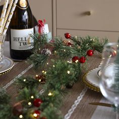 a bottle of wine sitting on top of a table next to plates and glasses filled with food