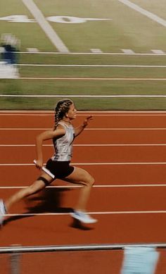 a woman running on a race track