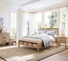 a bed room with a neatly made bed and two nightstands next to each other