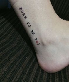 a person with a tattoo on their foot that says, born to be forty years old