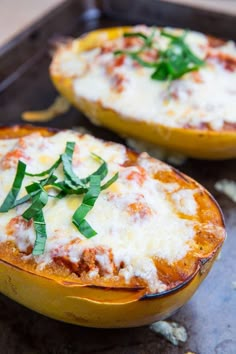 two stuffed squash halves with cheese and herbs