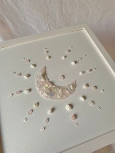 a white box with holes in it and a half moon on the inside, surrounded by small dots