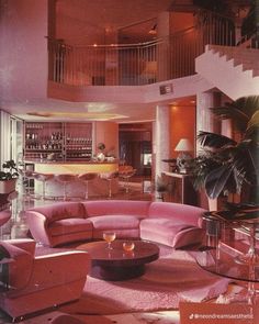 a living room filled with lots of furniture and a spiral staircase in the middle of it