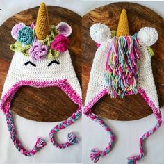 two crocheted unicorn hats with flowers on them