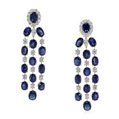 Blue Sapphire Earrings - Oval 39.05 Ct. - Platinum 950. The earrings primarily features with 26 blue oval shaped mixed brilliant cut sapphires, weighing a total of 39.05 carats. The sapphires have a clarity grade of very slightly included.   Also featured in the earrings are 42 white various shaped mixed brilliant cut diamonds, weighing a total of 7.32 carats. The diamonds have a clarity grade of very very slightly included - VVS1.   The earrings are entirely set in platinum 950. Sapphire Earring, Blue Sapphire Earrings, Sapphire Earrings, Blue Sapphire, Timeless Elegance, Diamonds