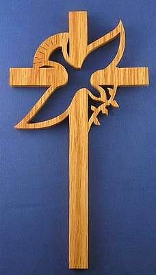 a wooden cross with a dove on it