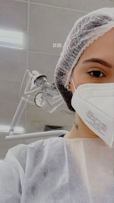 a woman wearing a surgical mask in a room