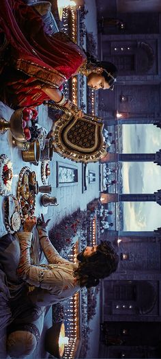 a man sitting in front of a table filled with lots of food and decorations on it