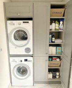 a washer and dryer in a small room next to some shelves with items