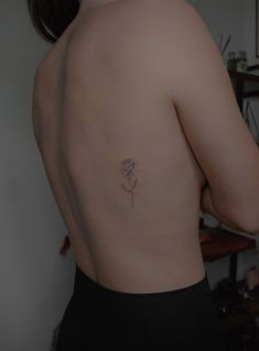 a woman with a flower tattoo on her back