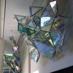 an abstract sculpture hanging from the ceiling in a building