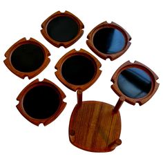 six pieces of wood with oval mirrors on them