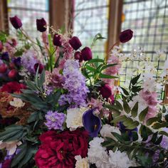 a vase filled with lots of different colored flowers