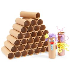 a stack of toilet paper tubes next to a cardboard tube holder and some other items