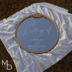 a wedding mirror sitting on top of a white cloth