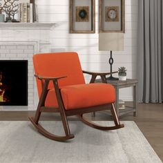 a rocking chair sitting in front of a fire place