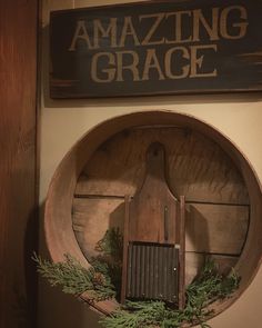 a wooden grater sitting on top of a shelf next to a sign that says amazing grace