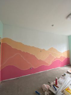 an empty room with pink and orange painted on the walls