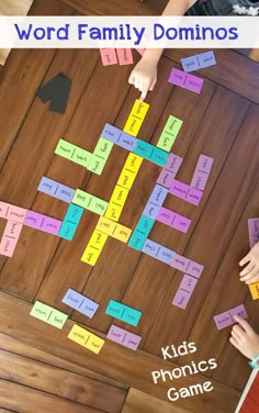 the word family dominos game is shown with two hands on top of each board