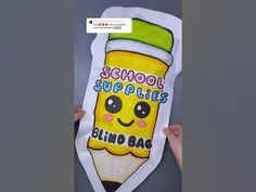 someone holding up a school supplies sign in front of a door that says, school supplies blingo bag