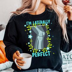 a woman wearing a black sweatshirt with the words i'm literally perfect on it