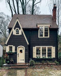 a black house with white trim and windows