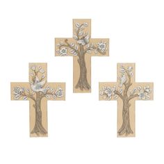 three wooden crosses with flowers and leaves on them