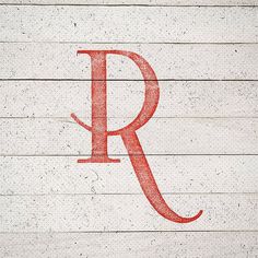 the letter r is painted red on wood