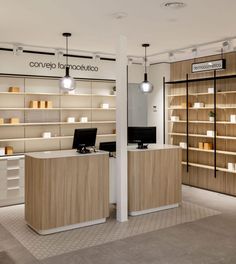 the interior of a retail store with wooden shelves and white lighting fixtures on either side of the counter