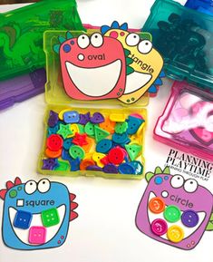 two plastic containers filled with lots of colorful buttons and magnets next to each other