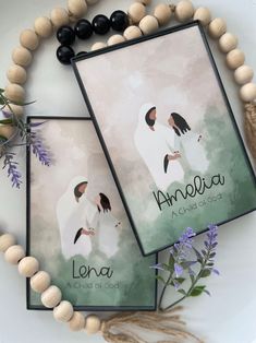 two personalized posters are displayed on a table with beads and flowers around them, along with bracelets